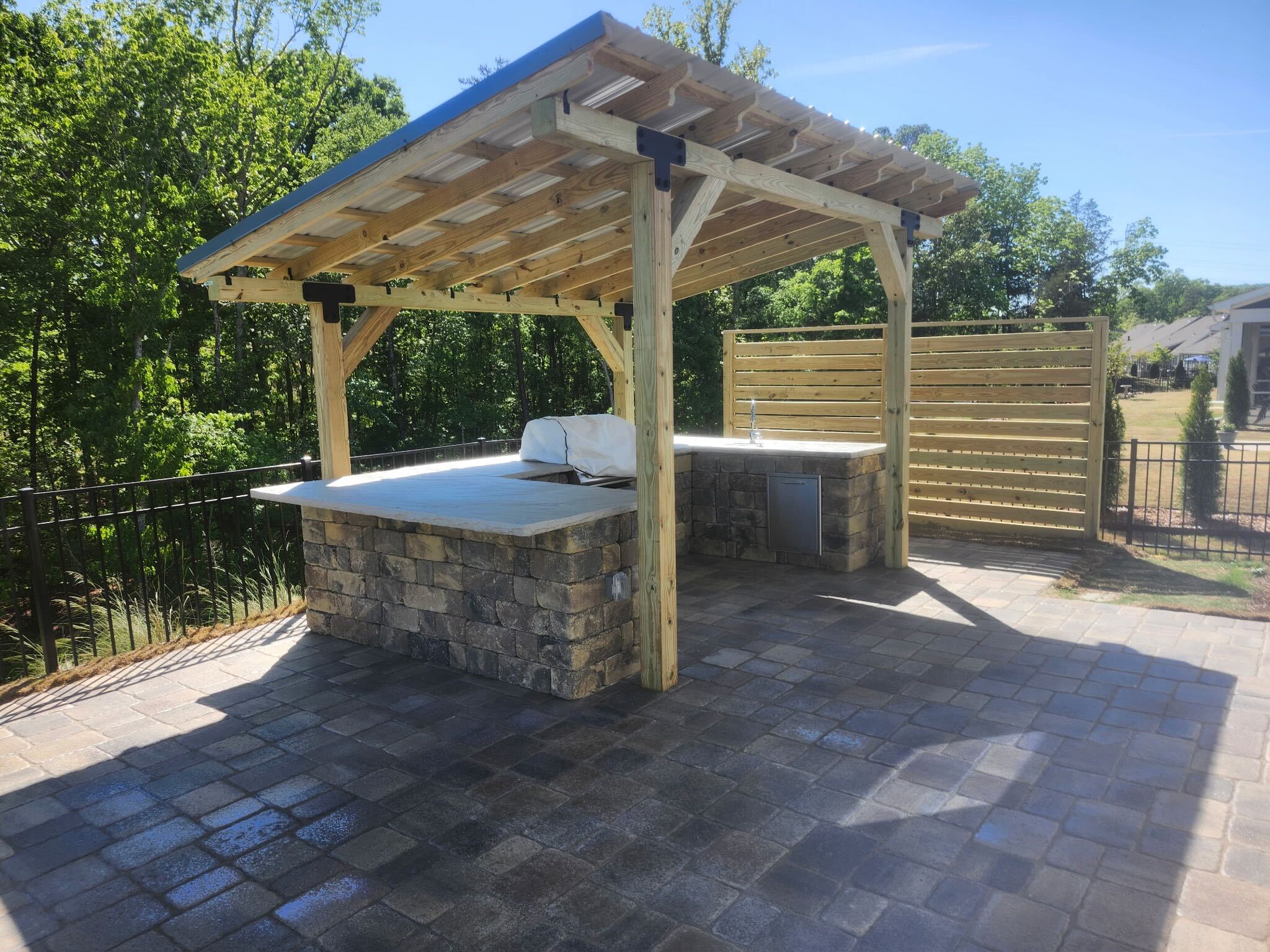 Cedar pergola and stone bar — close view
